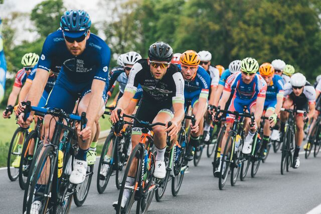 A peloton in a bicycle race, moving quickly in parallel.