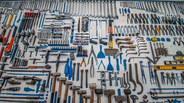 A large collection of tools laid out on a surface.